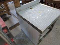 Klinger's under bar open storage with drain. NEW