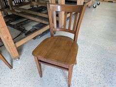 lot of ten wooden restaurant table chairs.