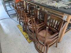 lot of ten wooden restaurant table chairs.