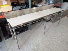 Regency stainless table with plastic cutting board tops.