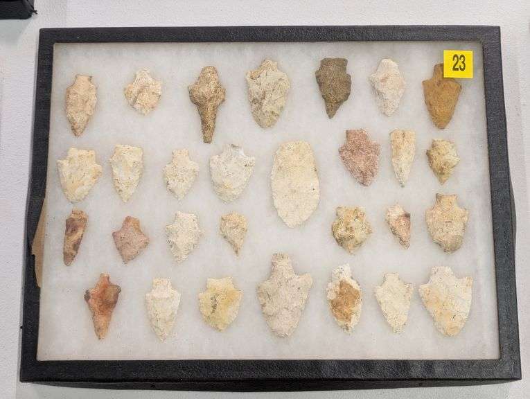 Collection of 29 arrowhead points in 12x16 riker display