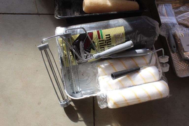 Tote of painting supplies Lee Real Estate & Auction Service