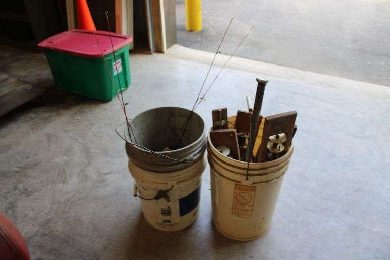 2 pails of ice fishing poles & tip ups