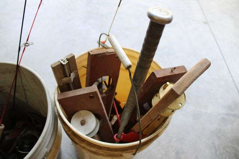 2 pails of ice fishing poles & tip ups
