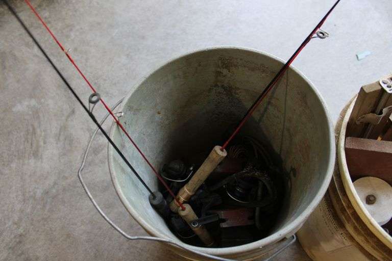 2 pails of ice fishing poles & tip ups