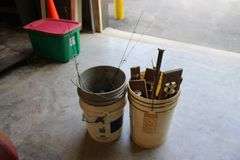 2 pails of ice fishing poles & tip ups