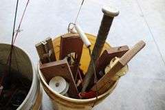 2 pails of ice fishing poles & tip ups