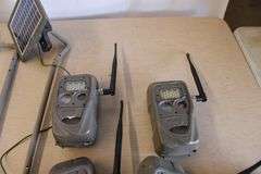 10 Cuddeback game cameras w/poles & accessories