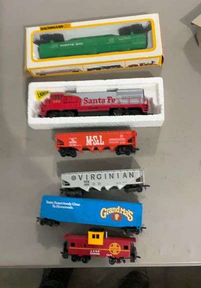 Assorted scale model train cars, engine
