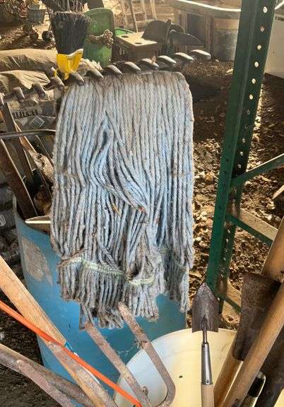 Plastic barrel containing handled tools-shovels, potato fork, rake, pruning shears, pry bar