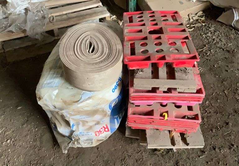 Roll of R30 fiberglass insulation, foam weatherstripping, plastic and wooden feed bag pallets