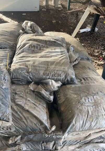 Pallet containing bagged, black mulch