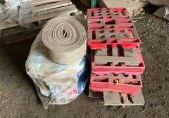 Roll of R30 fiberglass insulation, foam weatherstripping, plastic and wooden feed bag pallets