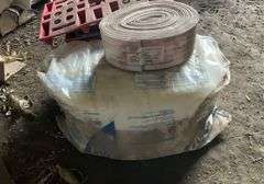 Roll of R30 fiberglass insulation, foam weatherstripping, plastic and wooden feed bag pallets