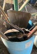 Plastic barrel containing handle tools-hoes,shovels, rakes,brooms, pry bar