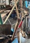 Plastic barrel containing handle tools-hoes,shovels, rakes,brooms, pry bar