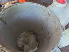Galvanized Bucket containing calf bottles, Ralgro 
