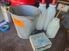 Galvanized Bucket containing calf bottles, Ralgro 
