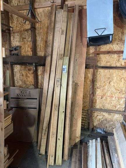 Larger lumber standing against the wall -located garage