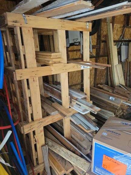 Custom built lumber rack with lumber – located garage