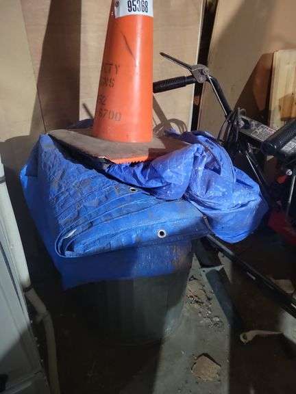 Galvanized trash cans containing tarps, safety cone – located garage
