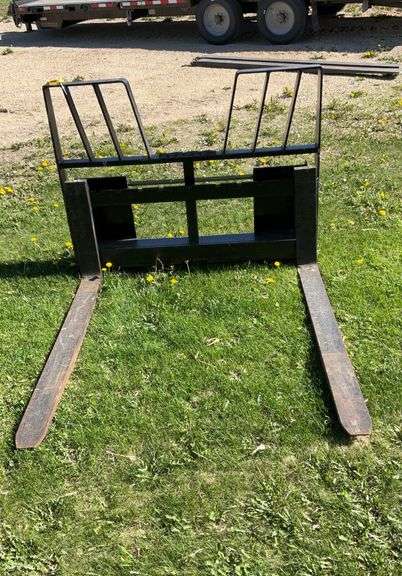 Skid loader mounted forks