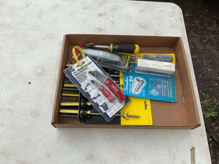 Flat with utility knives, office stapler, screw drivers