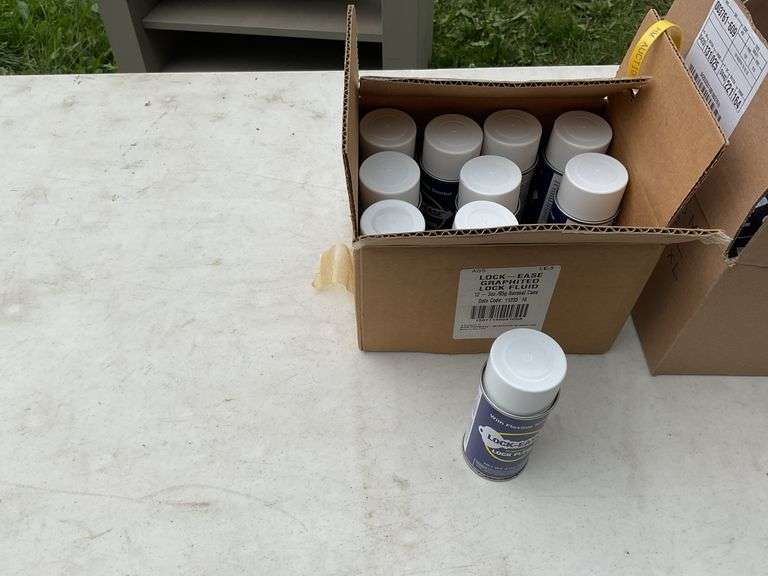 Box of graphite locking fluid & box of t-shirts