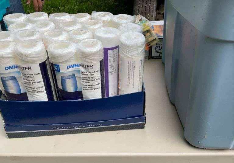 Tote of sediment filter cartridges & As seen on TV gadgets