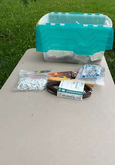 Tote of electrical supplies jig saw blades, wire staples, misc