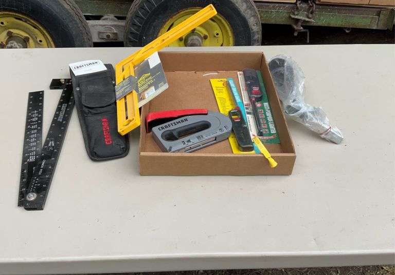 Flat with craftsman holding framer, oil filler, stapler grill lighters