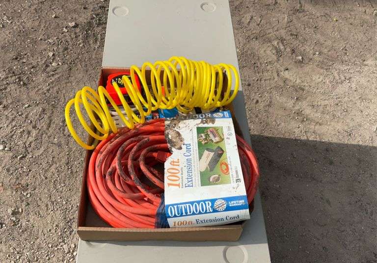 Flat with extension cords, power strip, tape measures, air hose
