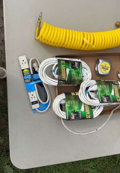 Flat of extension cords, power strips, tape measures, air hose