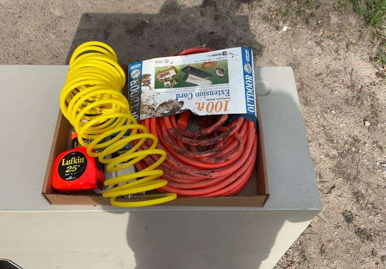 Flat with extension cords, power strip, tape measures, air hose