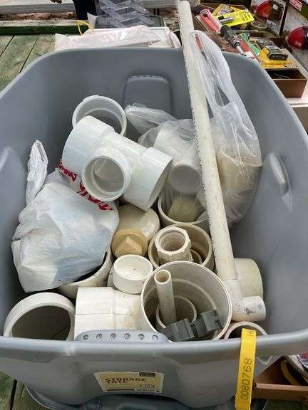 Tote of PVC pipe fittings