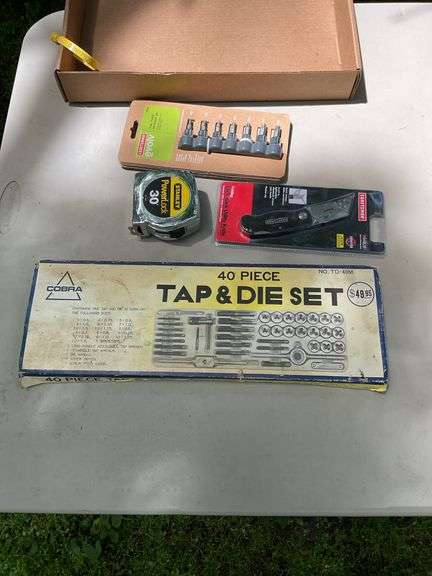 Flat of tap & die set, utility knife, tape measure, bits