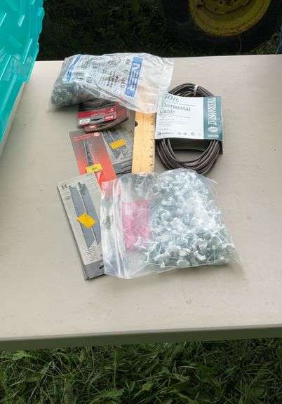 Tote of electrical supplies jig saw blades, wire staples, misc