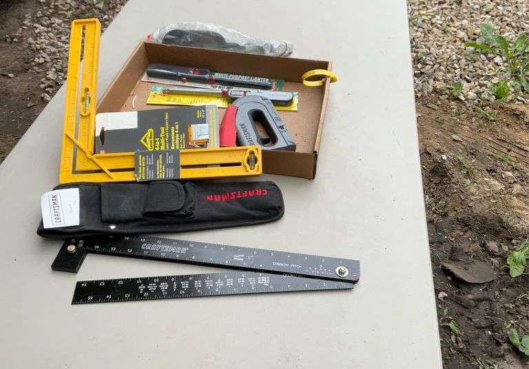 Flat with craftsman holding framer, oil filler, stapler grill lighters
