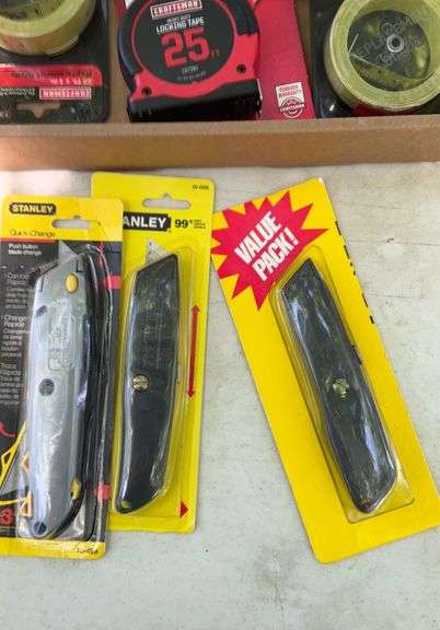 Flat of tape measures & utility knives