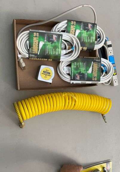 Flat of extension cords, power strips, tape measures, air hose
