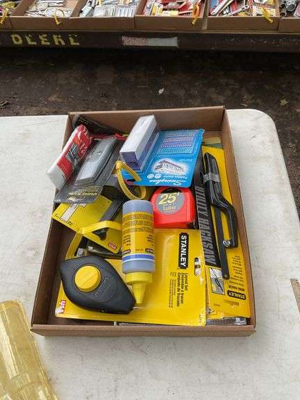 Flat with chalk line, tape measure, office stapler, utility hack saw