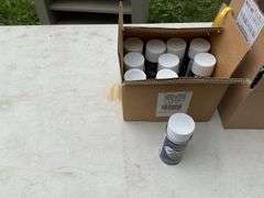 Box of graphite locking fluid & box of t-shirts