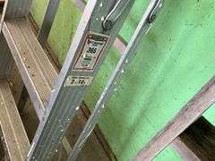 Aluminum step ladder and wood ladder