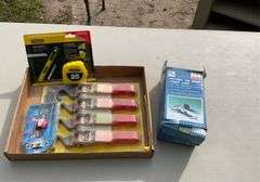 flat of tie down straps, tape measure & blade & LED keychain light