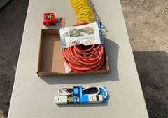 Flat with extension cords, power strip, tape measures, air hose
