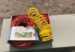 Flat with extension cords, power strip, tape measures, air hose