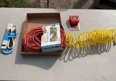 Flat with extension cords, power strip, tape measures, air hose