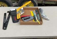 Flat with craftsman holding framer, oil filler, stapler grill lighters