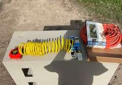 Flat with extension cords, power strip, tape measures, air hose