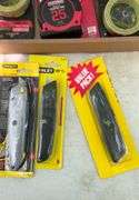 Flat of tape measures & utility knives
